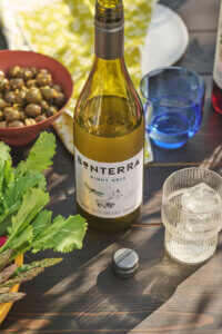 A bottle of Bonterra Pinot Gris set on a table surrounded by glassware and tapas