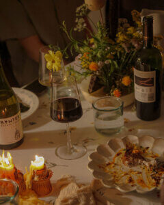 Candlelit dinner party with a glass of Bonterra Estate Cabernet Sauvignon