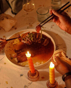 Steak Tataki recipe enjoyed by a group of people at a candlelit dinner table